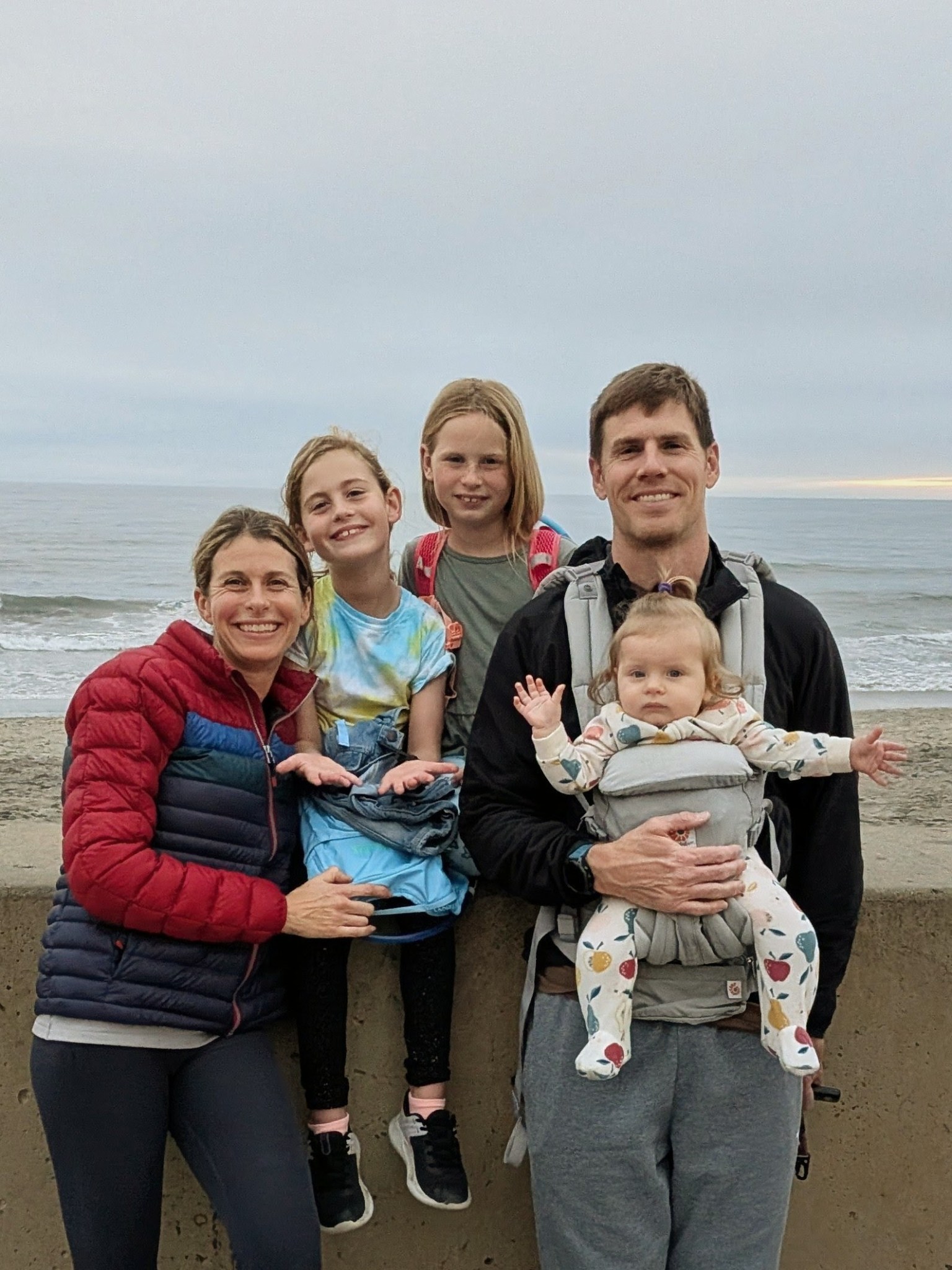 Dillon with his wife and three daughters by the ocean